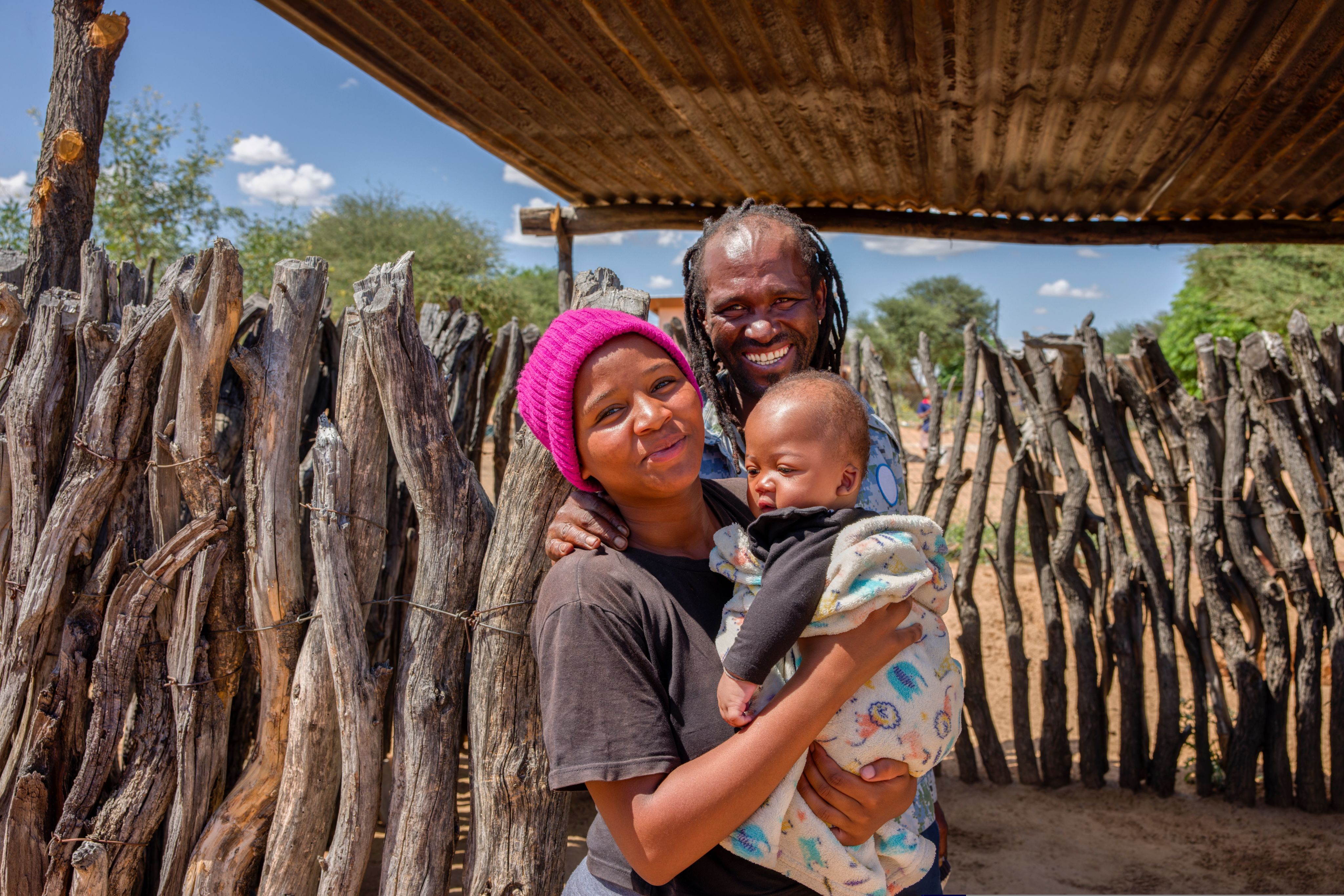 Parents pose for a photo with their child. © 2023 Lucian Coman/Shutterstock.com