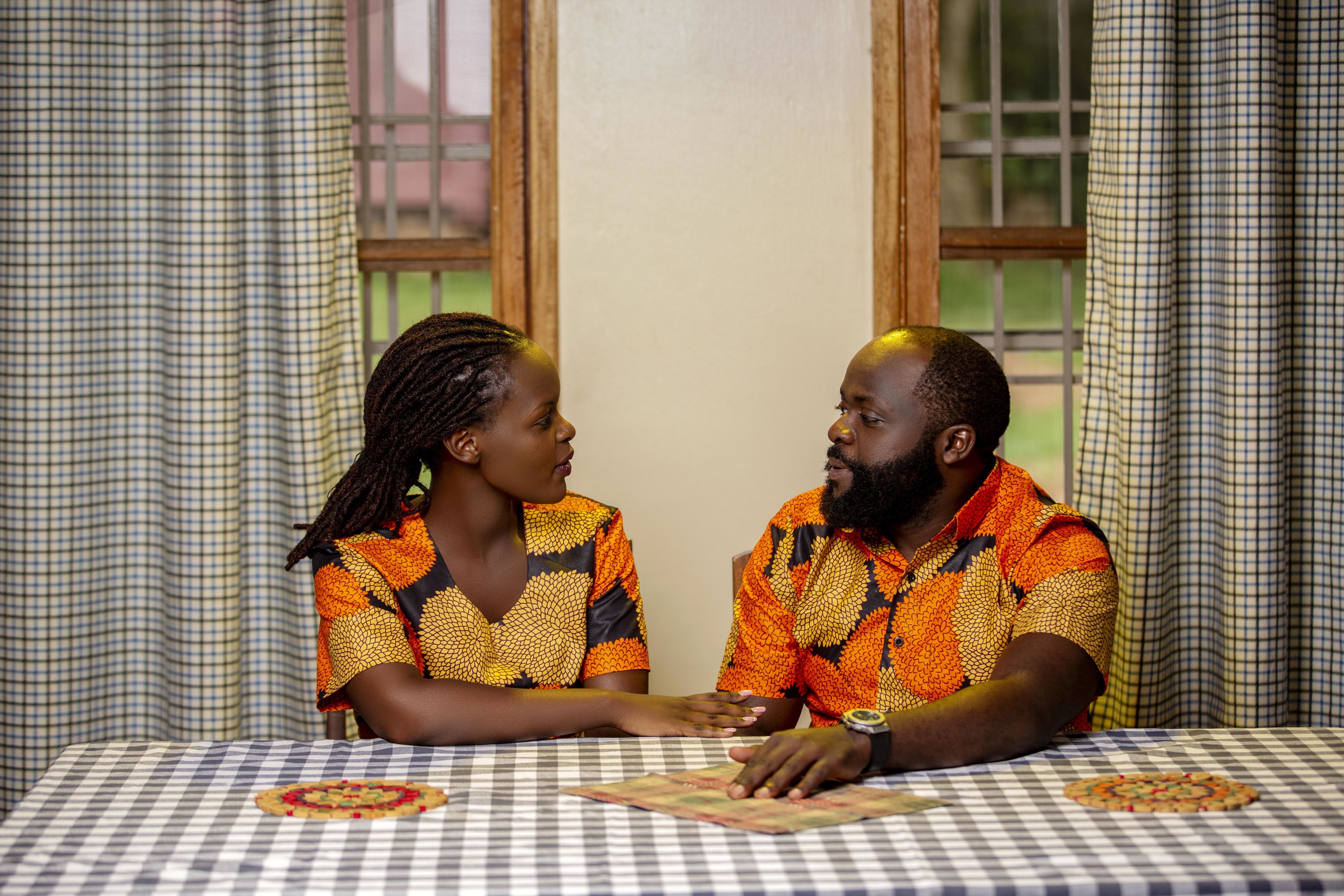 Photo of a couple sitting at a table talking to each other. The couple participated in the Becoming One program.