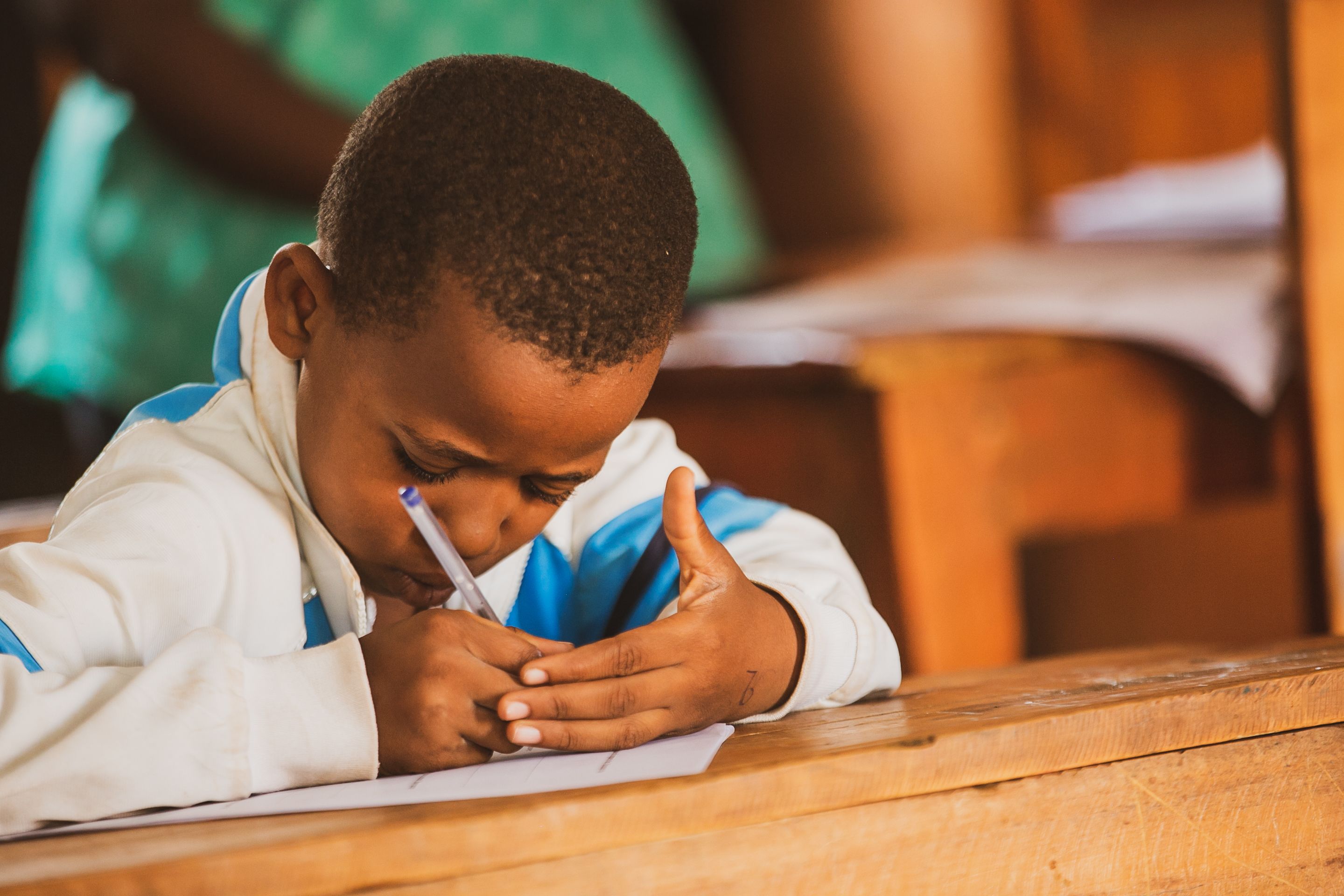 A student in Rwanda sitting at a desk while taking a STARS learning assessment