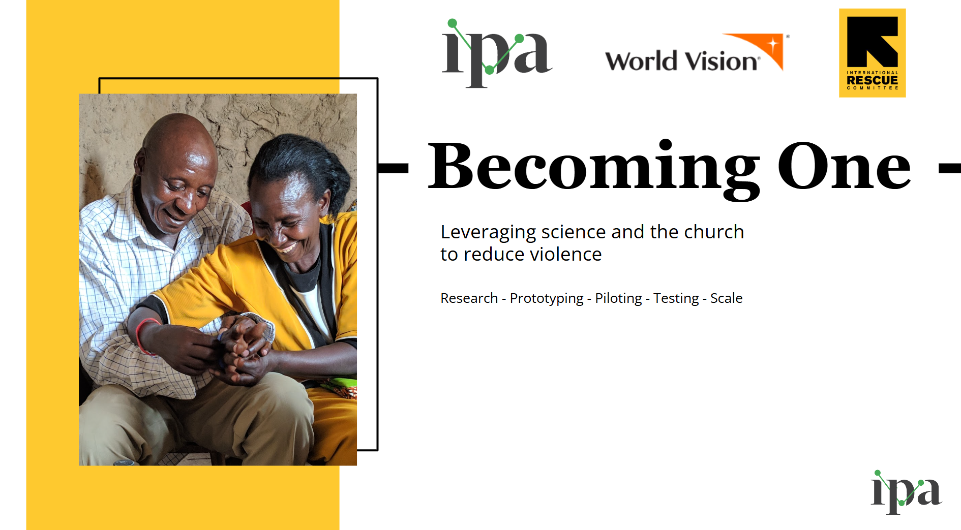 A photo of a man and woman sitting next to each other, gently holding hands and smiling