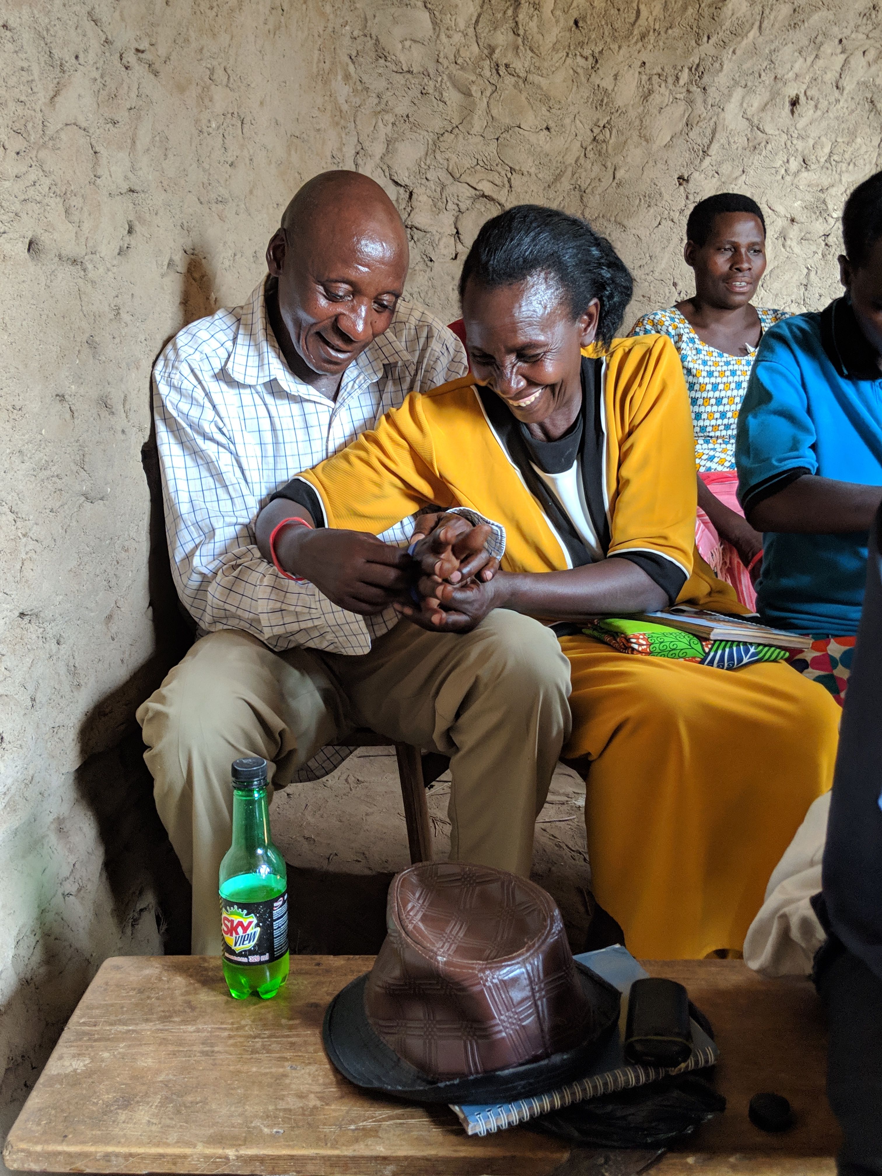 A couple sitting in a chair clasping hands